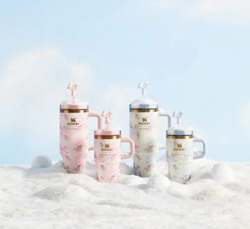 four stanley drink tumblers displayed on snow