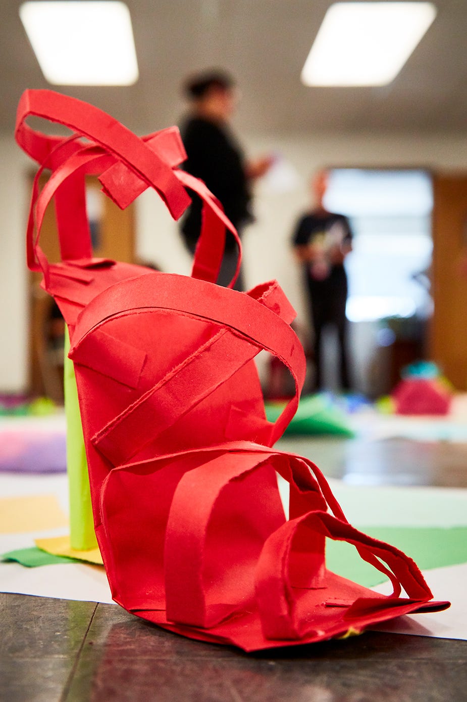 One of dozens of handmade paper shoes made by the artists at the California Institution for Women in Chino that came together to create the art installation “City Without a Name.”