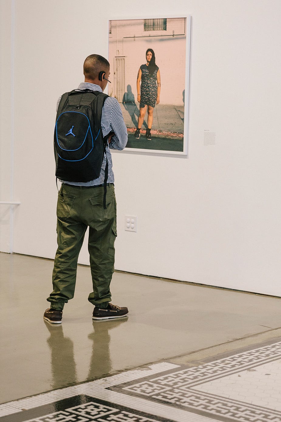 A visitor examines a photo at a recent Beta Main’s exhibit.