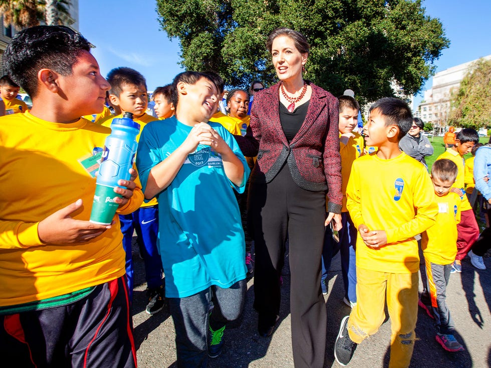Oakland Mayor Libby Schaaf mingles with participants at an event called Running for a Better Oakland, which encourages students, parents and volunteers to participate in a structured running program designed to build self esteem.