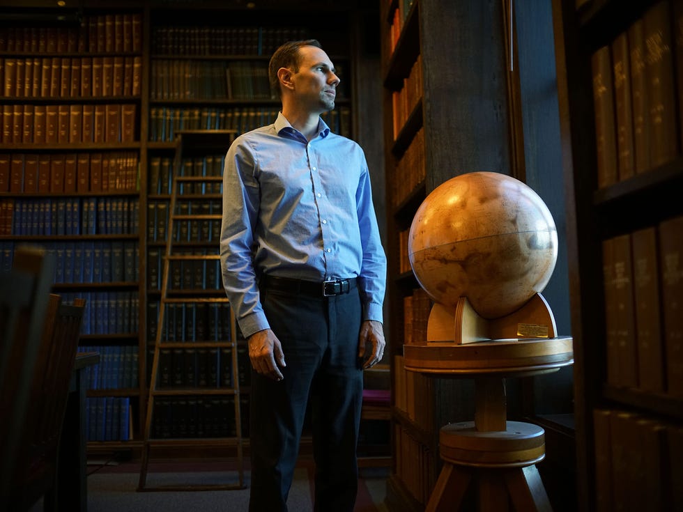 Tony Piro stands in the library at the Carnegie Institute in Pasadena.