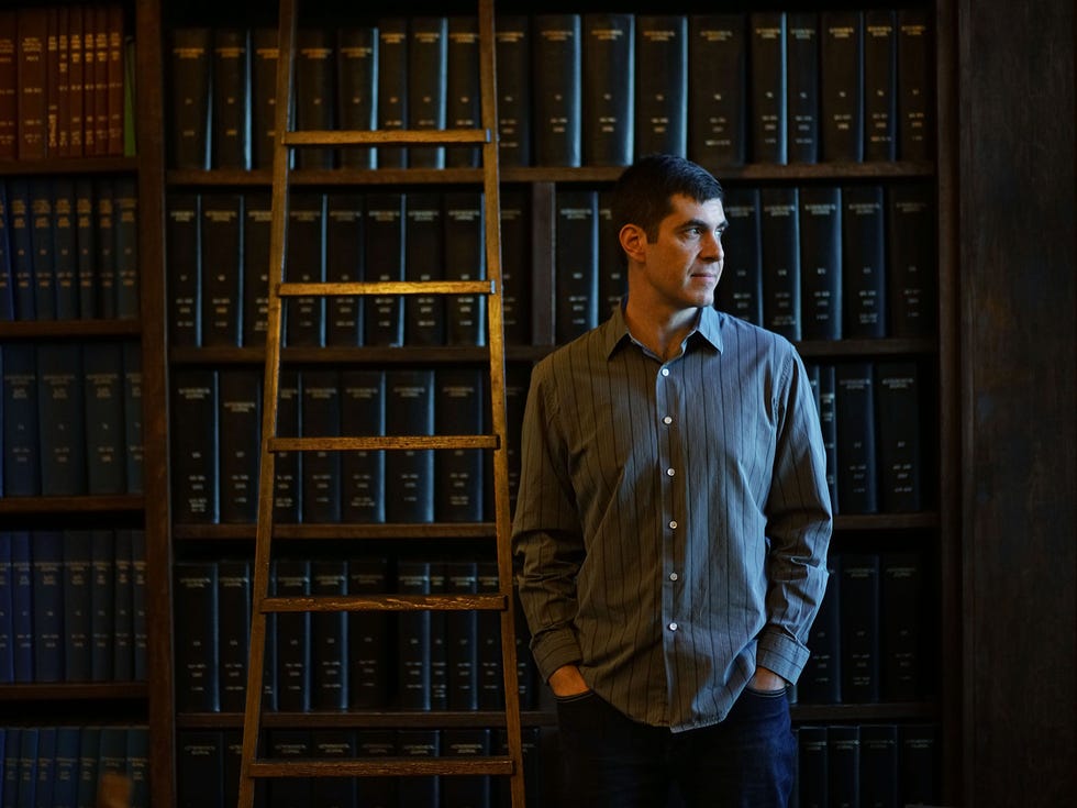 Josh Simon stands in the library at the Carnegie Institute in Pasadena.