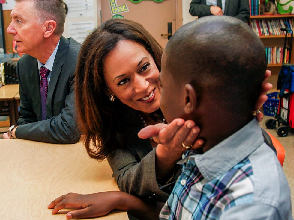 Then-Attorney General Harris speaking to a fifth-grade student during a visit to Baldwin Hills Elementary School in Los Angeles in 2014.