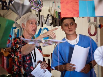 Angel, one of the prisoner-artists at the California Institute for Men in Chino, shows a guest around the installation portion of the collaborative multidisciplinary performance piece “Redemption."