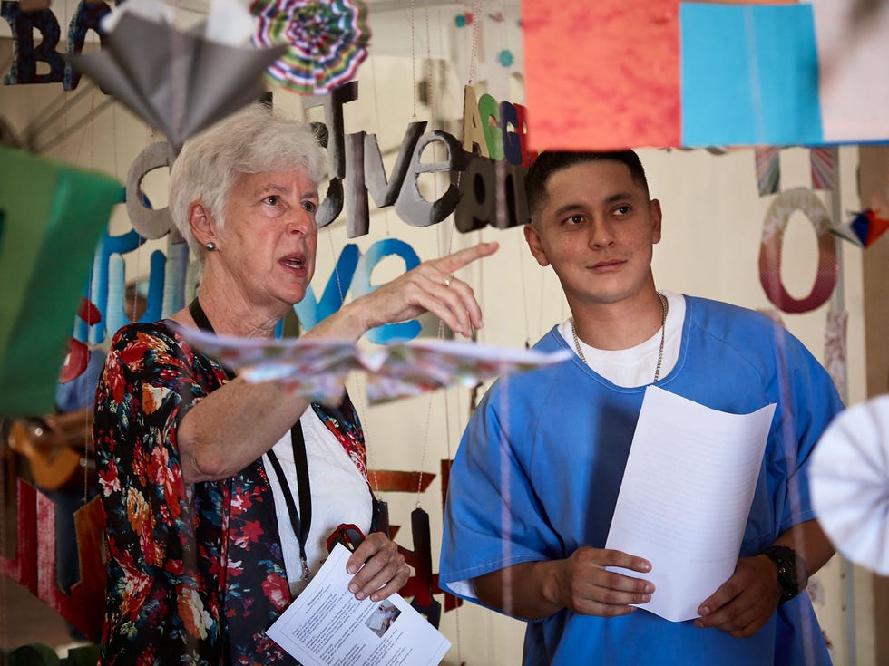 Angel, one of the prisoner-artists at the California Institute for Men in Chino, shows a guest around the installation portion of the collaborative multidisciplinary performance piece “Redemption."