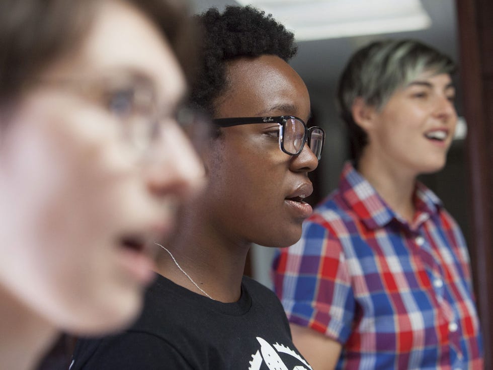 a group of women sing resistance themed songs during a practice session at the women’s center for creative work in los angeles
