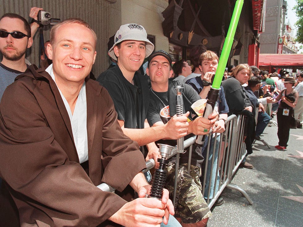 Star Wars fans with their light sabers as they wait in line for tickets to go on sale for 1999’s “Star Wars: Episode 1 — The Phantom Menace.”