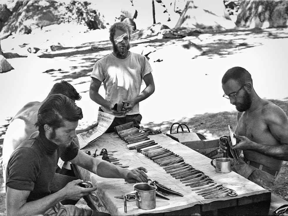Yosemite climbing pioneers Joe Fitschen, Chuck Pratt and Robbins sorting gear for a 1960 climb of the Nose of El Capitan.