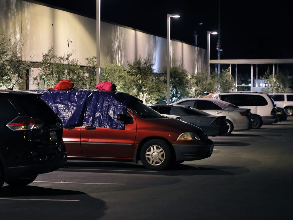 Homeless people in their cars are tucked in for the night at the Jewish Family Service of San Diego parking lot. Some cover the windows to block light and provide privacy.