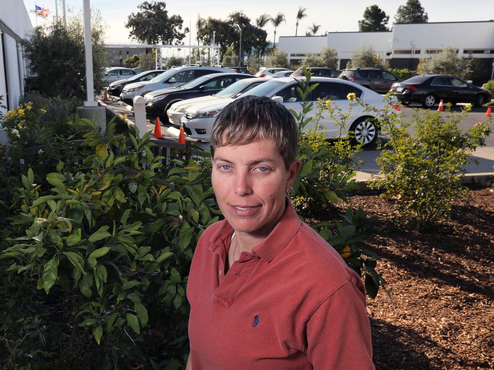 Teresa Smith, the founder and C.E.O. of Dreams for Change, with a partial view of the parking lot of the Jewish Family Service of San Diego. The organization allows homeless people can spend the night in their vehicles. The homeless people need to leave by 7:00 a.m.