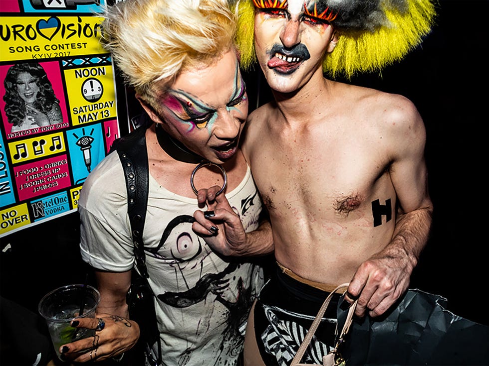 abhora pulls down on a friend's choker necklace at a dragcon after party at precinct in los angeles