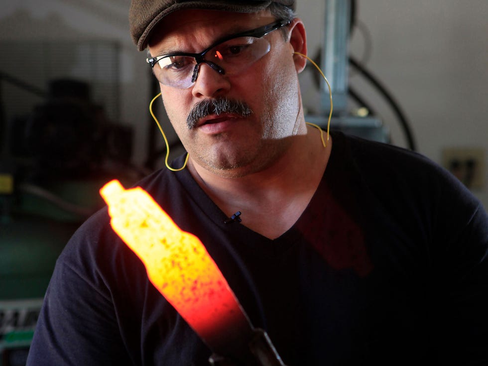 “Master smith” knife maker Aaron Wilburn checks the heating progress on a piece of Damascus steel that he is working into a chef’s knife at his workshop in Idaho Falls, Idaho.