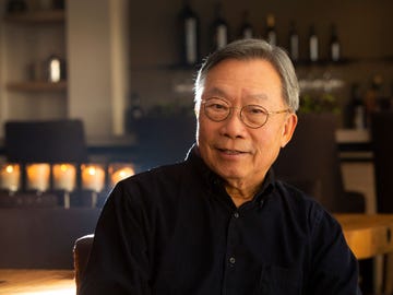 Stanley Cheng poses in his 10,000-bottle tasting room.