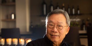 Stanley Cheng poses in his 10,000-bottle tasting room.