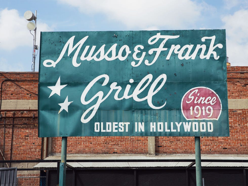 A sign in the rear parking lot hints at the colorful history inside the 100-year-old restaurant.