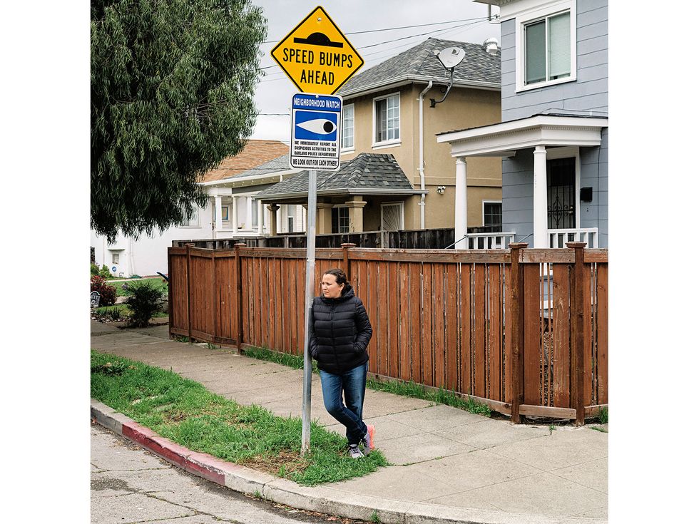 The author’s daughter, Tennessee Reed, by a Neighborhood Watch sign she helped lobby for to combat crime on her street.