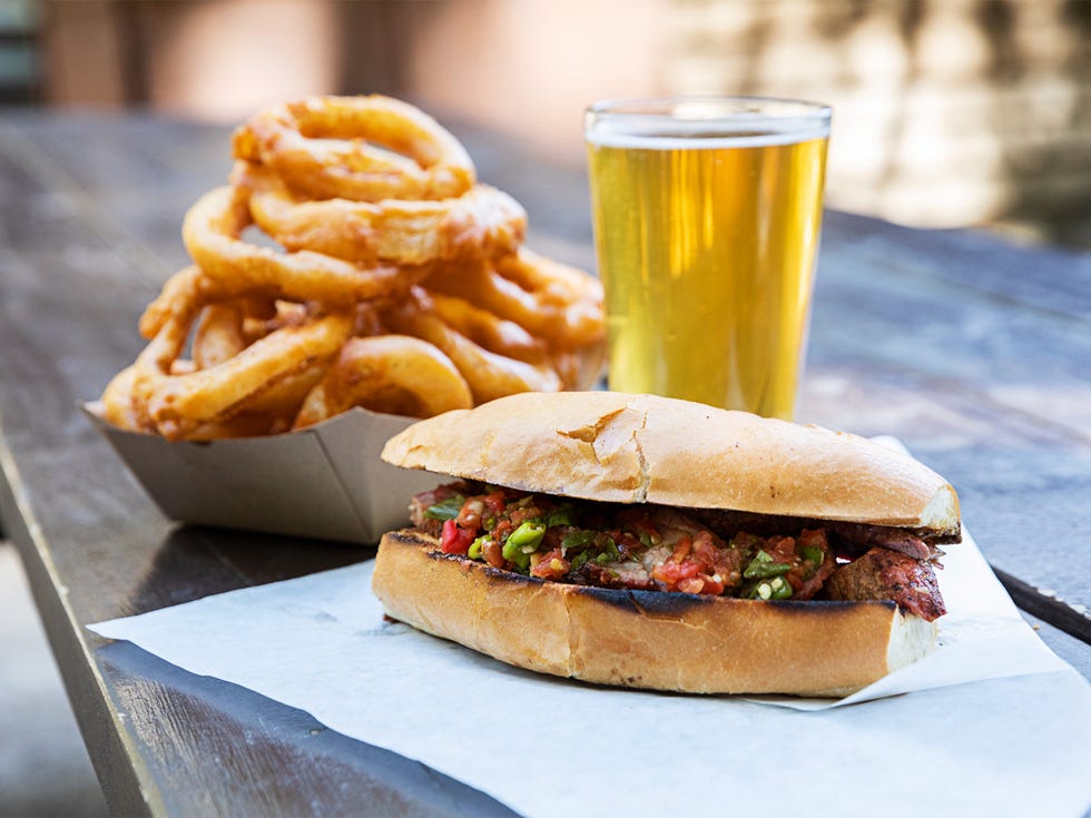 A tri-tip sandwich, onion rings, and draft beer make for simple pleasure.