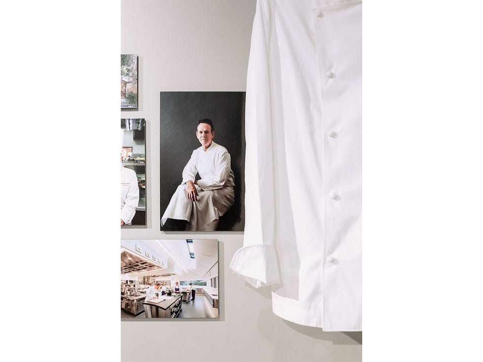 A chef’s jacket and photos are part of the display honoring Thomas Keller and his contributions to California cuisine.