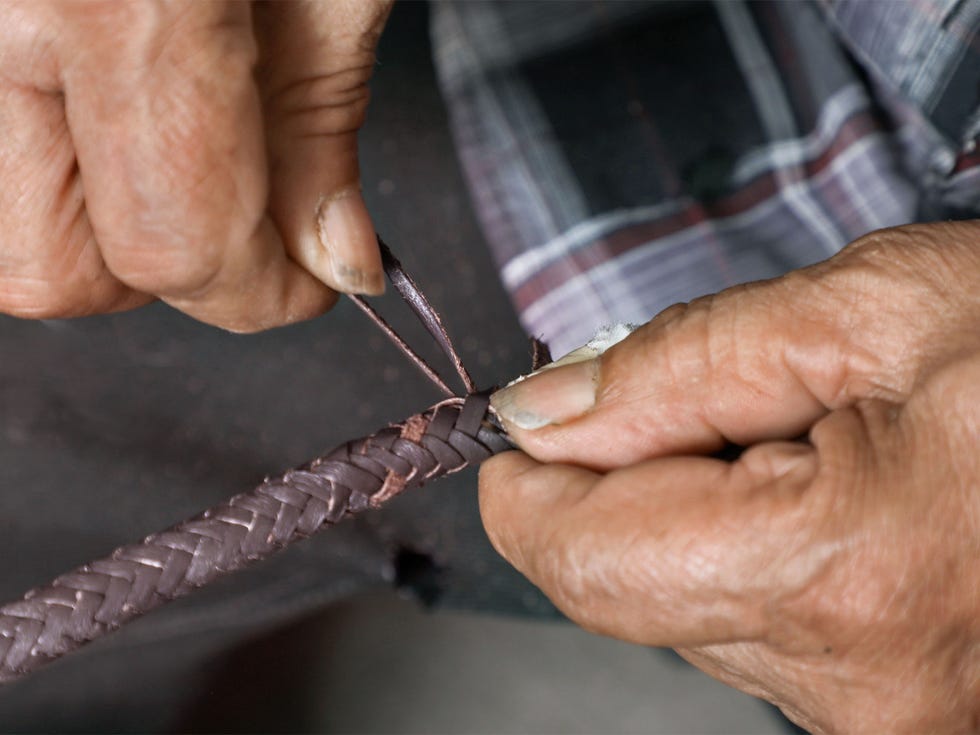 Medina demonstrates the intricate weaving required to produce a sturdy leather rein.