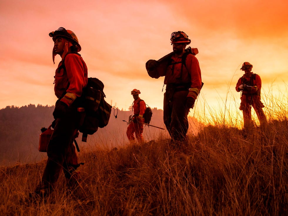 A crew of inmate firefighters make their way to firefighting operations to battle the Kincade Fire in Healdsburg, California on October 26, 2019. - US officials on October 26 ordered about 50,000 people to evacuate parts of the San Francisco Bay area in California as hot dry winds are forecast to fan raging wildfires.