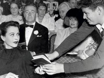 Hedy Lamarr signs an autograph book at the El Capitan Theatre in Hollywood, 1940. Photo from The Autograph Book of L.A.: Improvements on the Page of the City.
