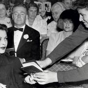 Hedy Lamarr signs an autograph book at the El Capitan Theatre in Hollywood, 1940. Photo from The Autograph Book of L.A.: Improvements on the Page of the City.