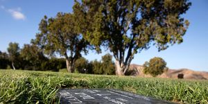 a black headstone marks the grave of juan peña diaz, an undocumented worker from mexico who was killed by anaheim police in 1953