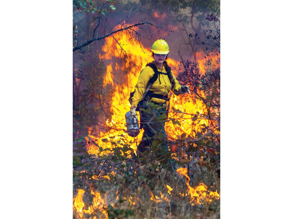 Lena Neuner, 25, participates in a controlled burn organized by the Klamath River Prescribed Fire Training Exchange (TREX) last October.