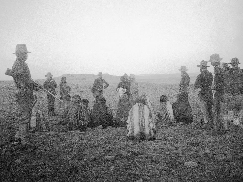 Hopi men under armed guard following their arrest by Captain Constant Williams at Orayvi, Arizona, 1894.