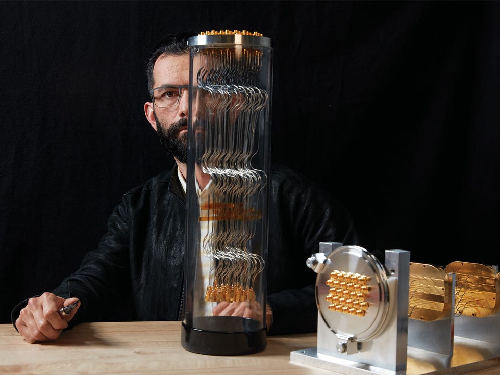 Google research scientist Erik Lucero with a quantum computer’s vacuum feedthrough, which holds coaxial cables used to carry microwave pulses to and from its processors.