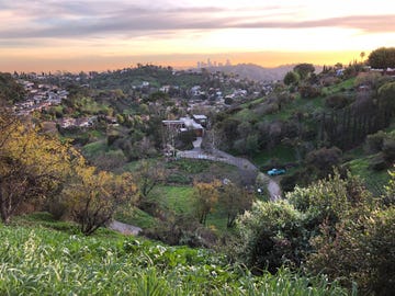 A photo of Angeles skyline and the author's farm (just to the left of blue truck) from a hilltop in Glassell Park.