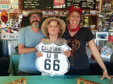 en route to their final destination of santa monica, the author far right, her husband, ed, and their son, isaac, stop at the bagdad cafe located in the mojave desert, it was the filming location for the 1987 german film of the same name