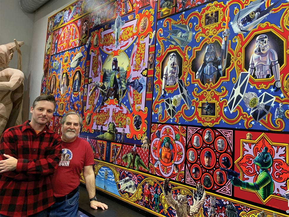 Sansweet and artist Robert Xavier Burden stand beside the largest known Star Wars painting ever made. Fifteen feet across by eight feet tall, Burden’s masterwork depicts 150 Star Wars toys. Fittingly, missile-launching Boba Fett appears dead center, against a gauzy landscape inspired by Leonardo da Vinci’s Mona Lisa.