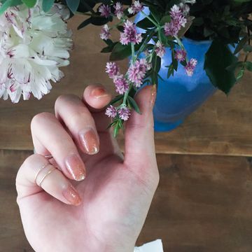 Finger, Flower, Petal, Flowering plant, Purple, Gesture, Nail, Thumb, Floral design, Artificial flower, 