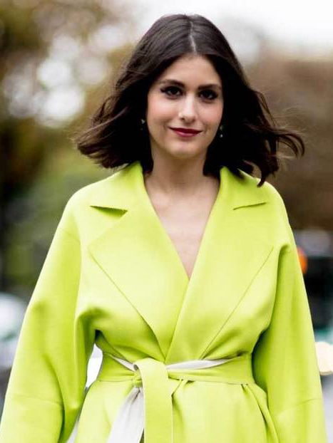 Clothing, Hairstyle, Yellow, Sleeve, Green, Coat, Outerwear, Collar, Facial expression, Formal wear, 