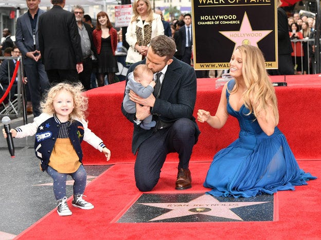 Human, Flooring, Red, Carpet, Suit, Costume accessory, Flag, Premiere, Sun hat, Costume hat, 