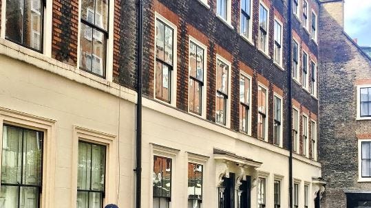 Window, Bicycle tire, Bicycle wheel, Jeans, Bicycle frame, Jacket, Denim, Facade, Town, Neighbourhood, 