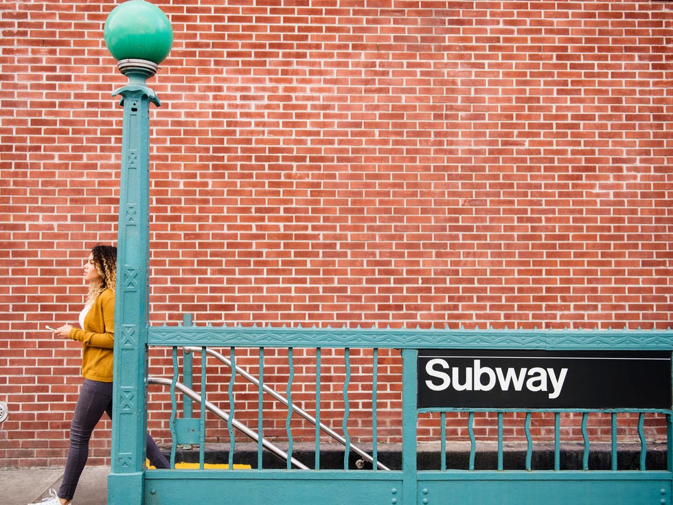 Human, Brick, Wall, Line, Street light, Teal, Street fashion, Signage, Brickwork, Composite material, 