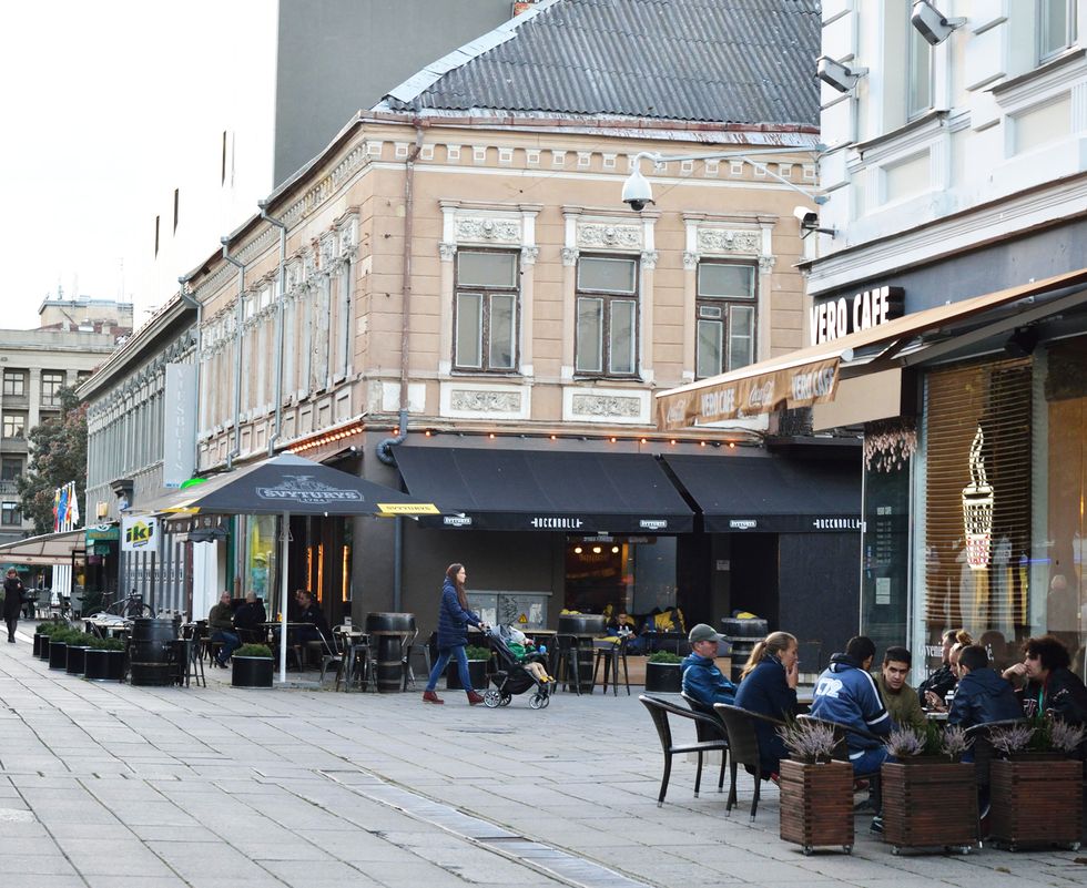 Window, Town, Furniture, Mixed-use, Outdoor furniture, Flowerpot, Awning, Outdoor table, Restaurant, Cobblestone, 