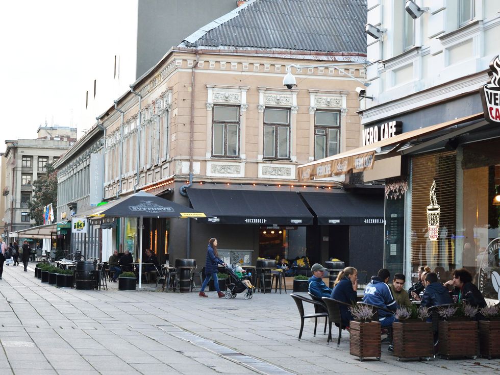 Window, Town, Furniture, Mixed-use, Outdoor furniture, Flowerpot, Awning, Outdoor table, Restaurant, Cobblestone, 