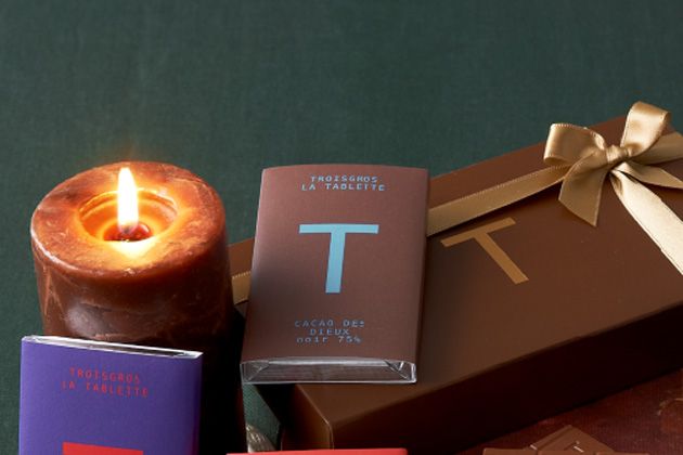Lighting, Candle, Peach, Paper product, Confectionery, Chocolate, Wax, Chocolate bar, Packaging and labeling, Still life photography, 