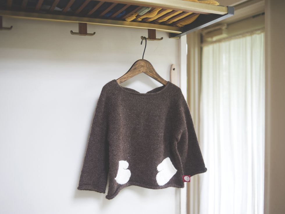 Brown, Sleeve, Sweater, Textile, Interior design, Clothes hanger, Ceiling, Woolen, Grey, Beige, 