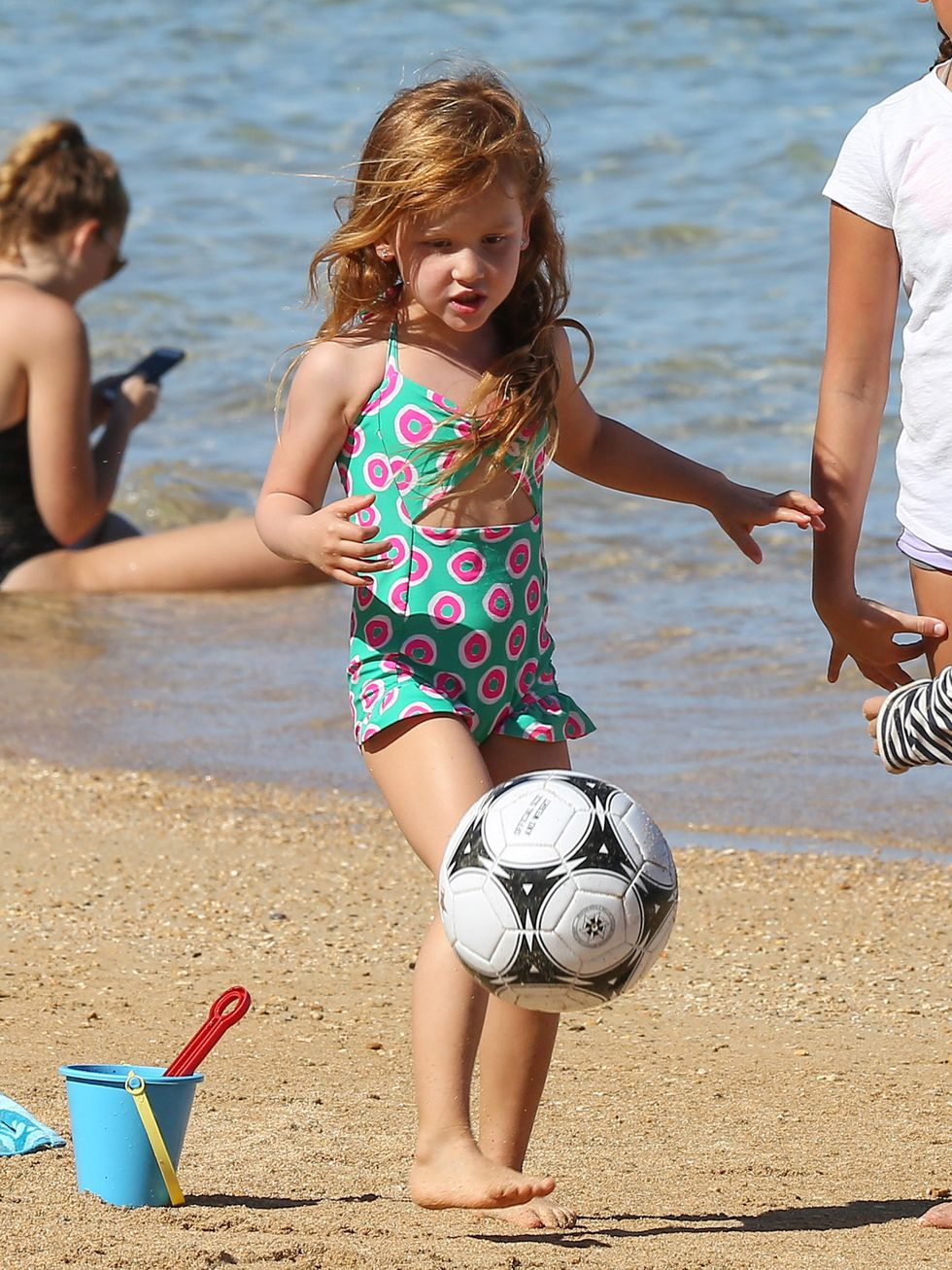 Arm, Fun, Ball, Football, Sports equipment, Human leg, Soccer ball, Summer, People in nature, People on beach, 