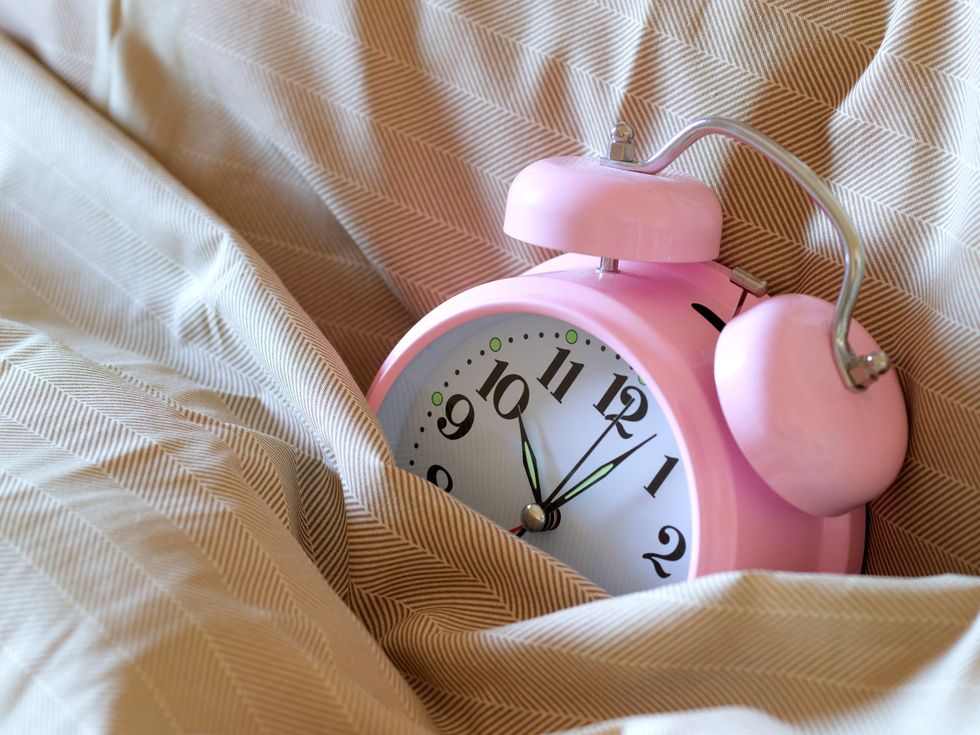 Alarm clock, Pink, Clock, Product, Watch, Material property, Sleep, Hand, Home accessories, Wrist, 