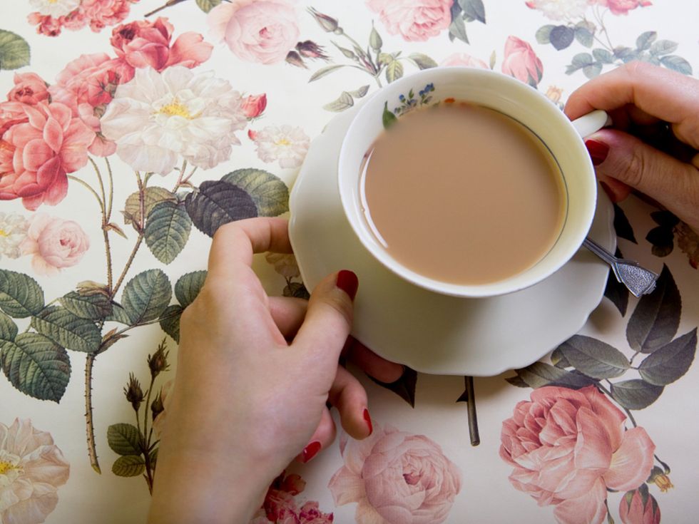 Cup, Teacup, Pink, Cup, Coffee cup, Hand, Petal, Tableware, Tea, Drinkware, 