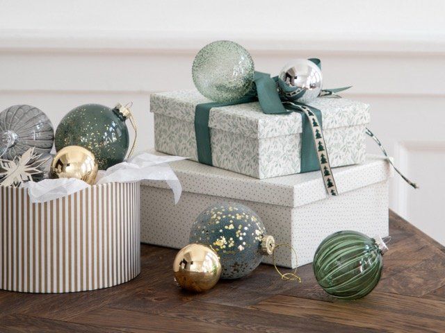 Christmas decoration, Room, Gift wrapping, Wood, Furniture, Sphere, Christmas ornament, Interior design, Table, Ornament, 