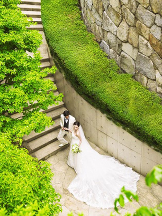Clothing, Green, Dress, Wedding dress, Bridal clothing, Bride, Marriage, Gown, Ceremony, Stone wall, 