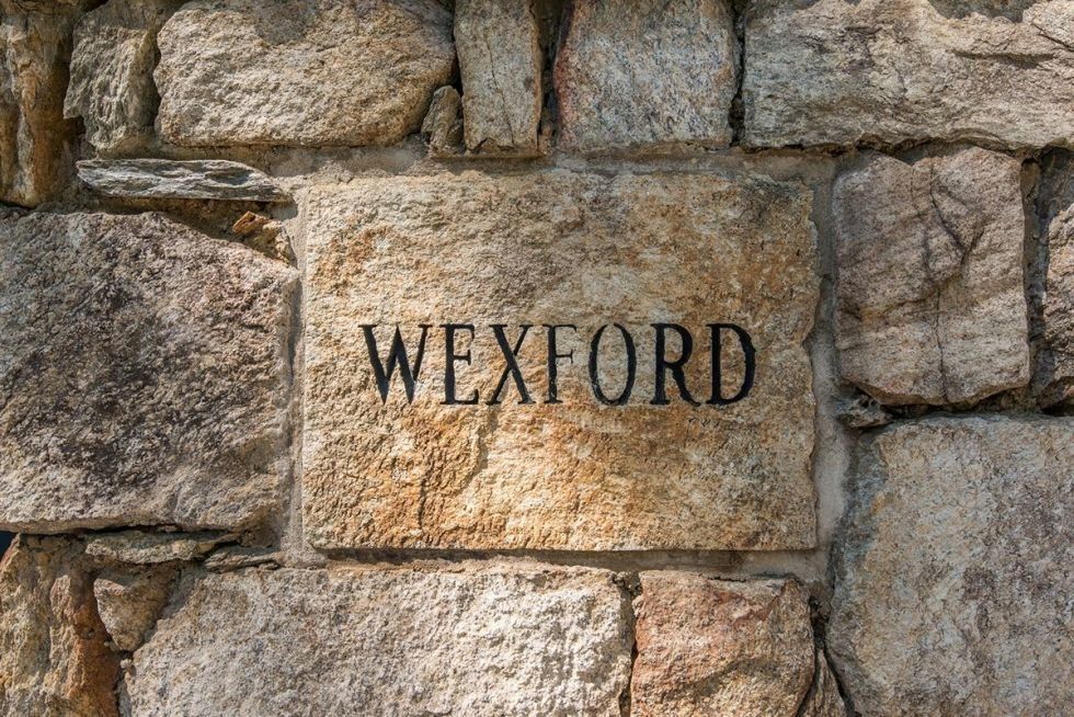 Stone wall, Wall, Text, Rock, Stone carving, Limestone, Ancient history, Font, Carving, History, 