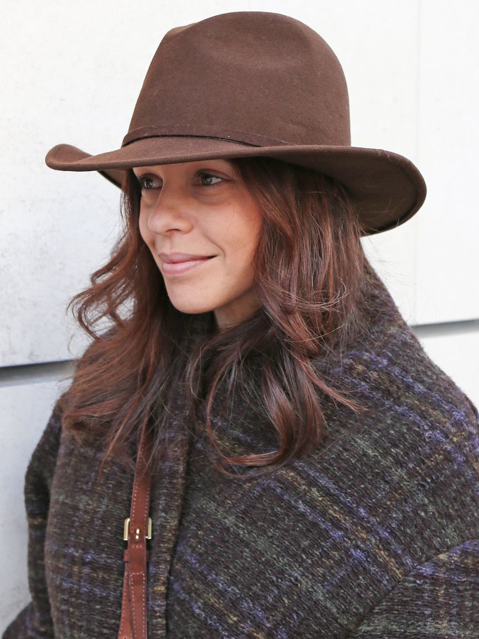 Clothing, Hat, Lip, Mouth, Brown, Sleeve, Textile, Outerwear, Facial expression, Sweater, 