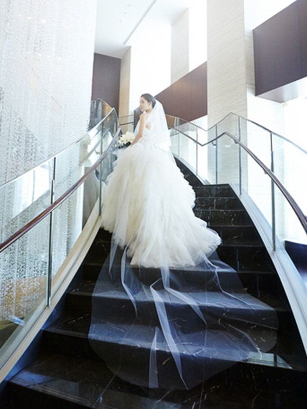 Dress, Bridal clothing, Shoulder, Gown, Bride, Formal wear, Wedding dress, Bridal party dress, Stairs, Bridal accessory, 